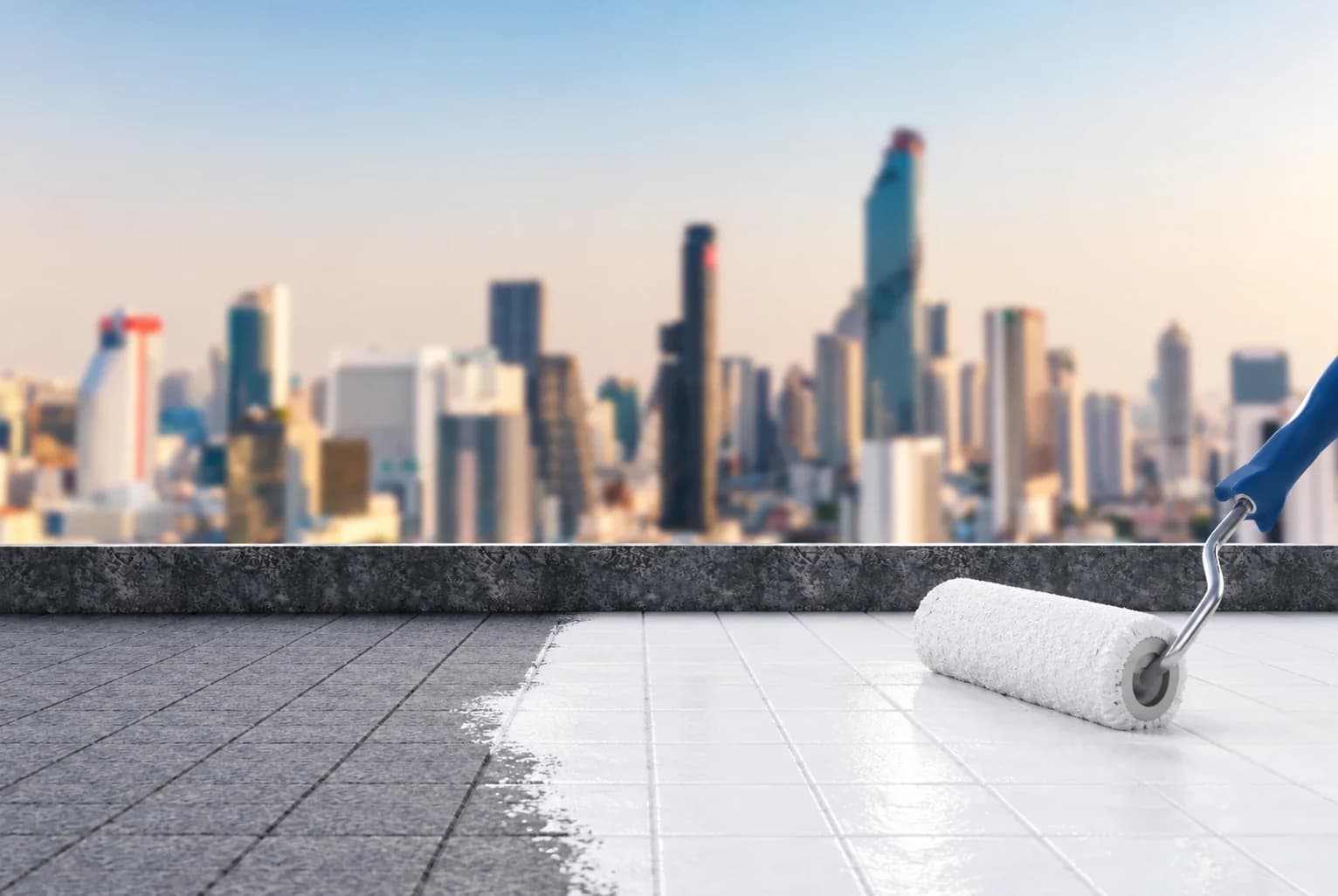A roller coating a rooftop's tiles in white waterproofing, with a city skyline behind